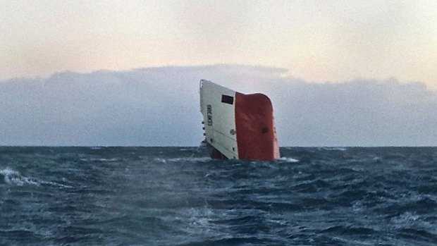 Eight missing ... Cypriot-registered cargo vessel Cemfjord slips into the sea some 24 kilometres from Wick in northeast Scotland on Saturday.