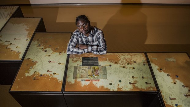Artist/film maker Curtis Taylor, with 'touch tables' containing his film in the new exhibition, Kaninjaku: Stories from the Canning Stock Route at the National Museum of Australia. 