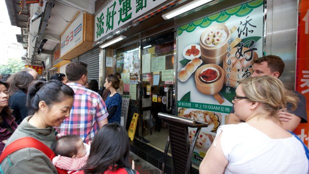 Cue the taste: Queuing outside tim Ho Wan restaurant in Kowloon, Hong Kong.