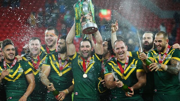 Cameron Smith lifts the trophy with teammates after victory in the Four Nations final in 2016.