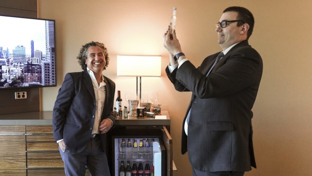 Managing Director of Just In Case Direct Paul Berman and Grand Hyatt food and beverage division manager Henri Sarrasin take a look at the minibar in Melbourne's Grand Hyatt.