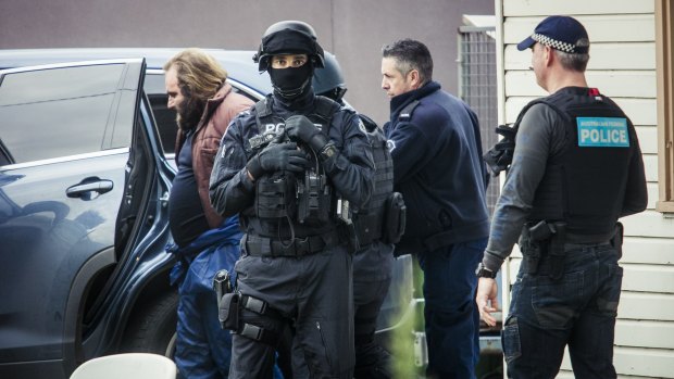 Phillip Galea is led from a house by police during a terror raid in Ballarat Road, Braybrook, on Saturday.