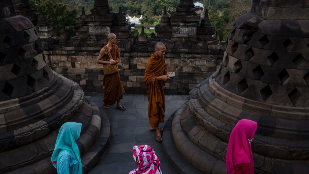 Buddhist monks and sightseers  at Borobudur temple  in Central Java.