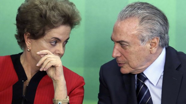 Brazilian President Dilma Rousseff, pictured talking to Vice-President Michel Temer, is trying to fight off impeachment.