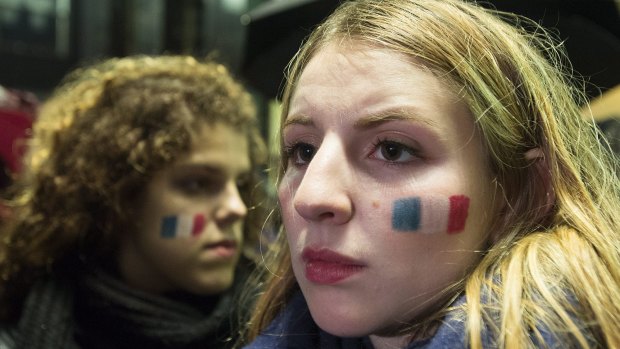 People attend a vigil outside the French consulate in Montreal, Canada, following the terror attacks in Paris. 
