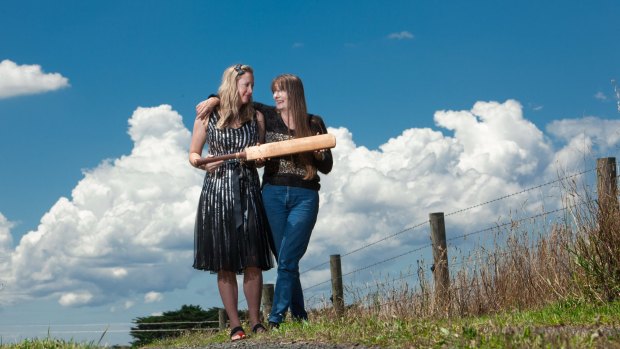 Lennie Gwyther's granddaughter, Sally, and daughter, Mary, with a cricket bat given to him by Sir Donald Bradman.