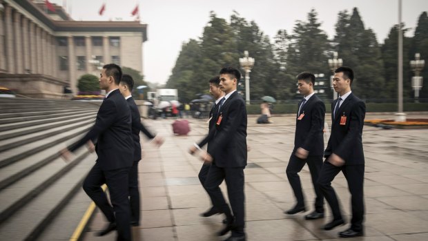 Security personnel walk towards the Great Hall of the People after the opening of the Communist Party Congress this week.