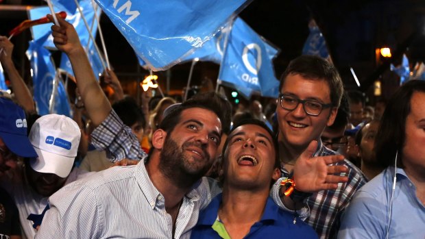 Followers of Spain's acting Prime Minister  Mariano Rajoy celebrate the election results in Madrid.