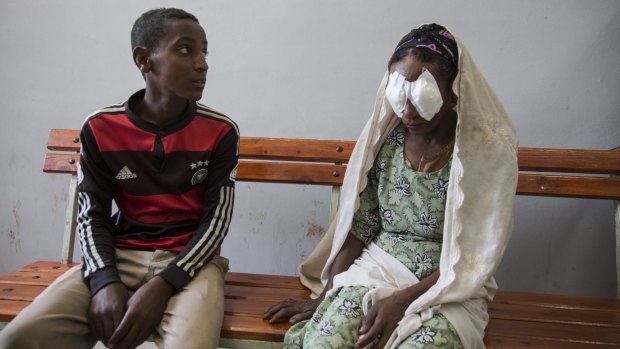 Kemal Abagojam, 15, sits next to his mother Abagojam, who has just come out of trachiasis surgery at Seka Chekorsa Primary Hospital.