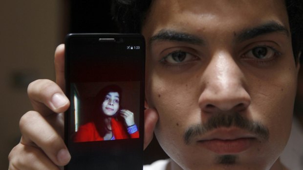 Hassan Khan shows the picture of his wife Zeenat Rafiq, who was burnt alive.