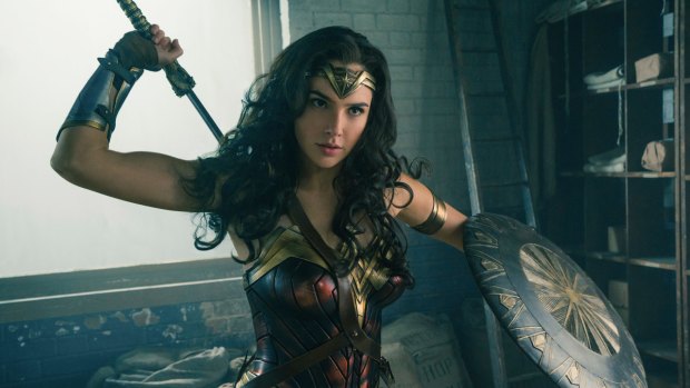 Gal Gadot wields her weapons in a scene from <i>Wonder Woman</i>.