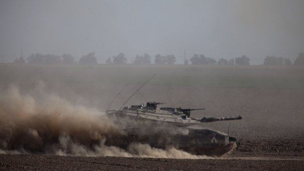 An Israeli tank moves along the border with the Gaza Strip during Operation Protective Edge.