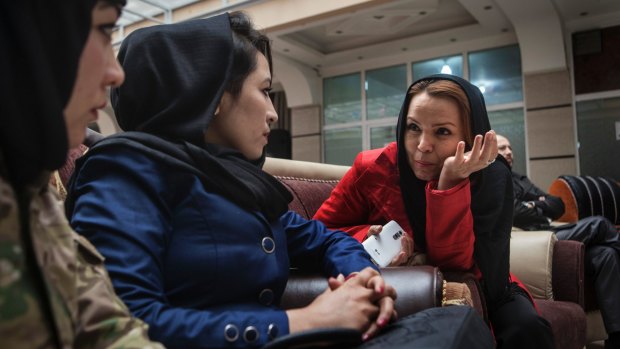 Zahra Yaganah, right, an activist, writer and divorced mother of two teenagers, speaks with Fatima Qasemi, left, and Gulab Hiaidari at an International Women's Day event in Kabul.