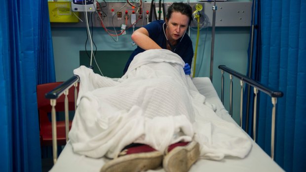 Dr Clare Foss treats an intoxicated male in the emergency department at Calvary Hospital.
