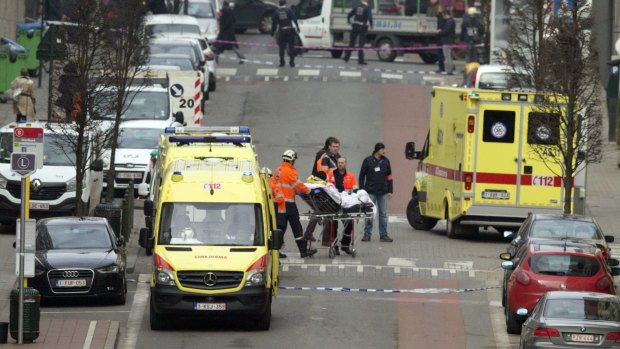 A victim of the Maalbeek metro station blast is taken from the scene by paramedics.