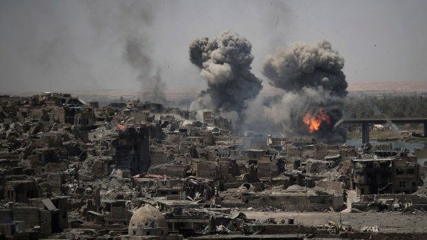 Airstrikes target Islamic State positions on the edge of the Old City in Mosul, Iraq in July. 