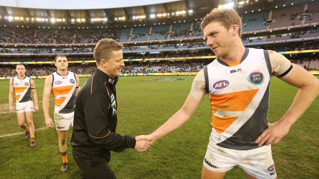 Tigers coach Damien Hardwick and Lachie Whitfield of the Giants shake hands after the match.