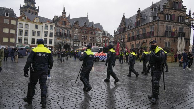 Police patrol the city centre in Nijmegen, eastern Netherlands, after an anti-lockdown protest was banned.