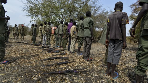 Children surrender their weapons during a ceremony formalising their release from the SSDA Cobra Faction armed group, in South Sudan.