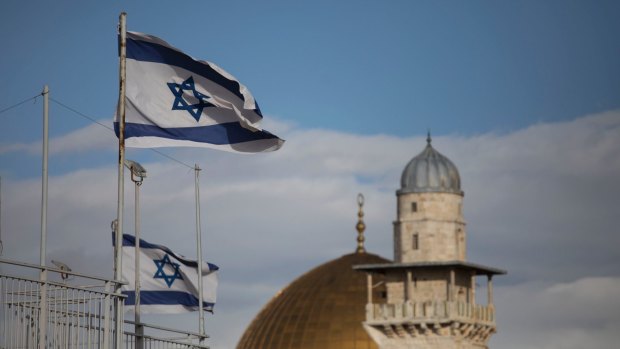 Israeli flags fly near the golden Dome of the Rock in the al-Aqsa mosque compound in the occupied Old City of Jerusalem. Benjamin Netanyahu has rejected the formula of "land for peace" in dealing with the stateless Palestinians, instead advocating "peace for peace" while settlement of occupied territory continued.
