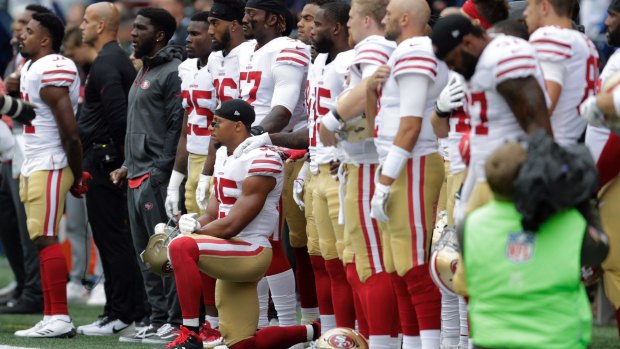 San Francisco 49er Eric Reid kneels for human rights during the US national anthem before an NFL game on September 17.