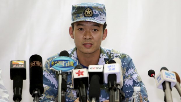 Diver Guan Dong speaks at a news conference after receiving a first-class merit for rescuing a 21-year-old sailor from the capsized ship Eastern Star on the Yangtze River by giving him his diving gear, on Wednesday. 
