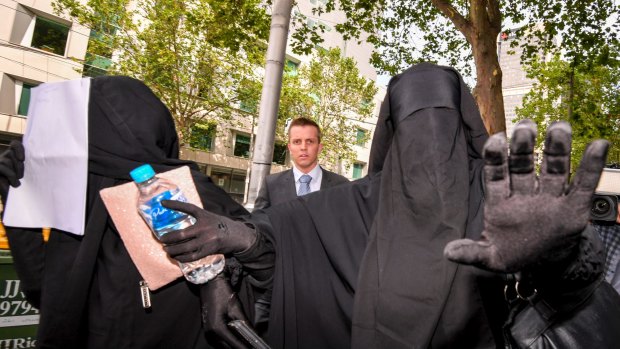 Women believed to be friends or family of the accused terrorists leave Melbourne Magistrates Court.