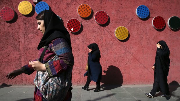 Pedestrians walk in downtown Tehran, Iran.