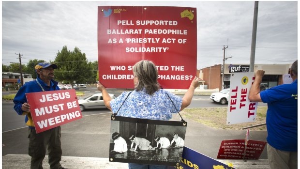 Protesters against child abuse within the Catholic Church stand  the front of the Ballarat Magistrate's Court before the Royal Commission into Institutional Responses to Child Sexual Abuse begins.