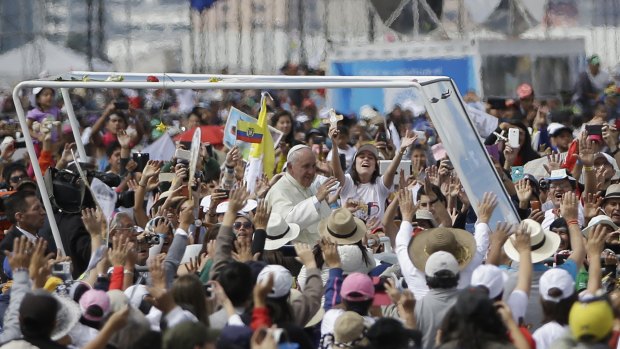 Pope Francis rides through the crowd in his popemobile as he arrives to celebrate Mass at Bicentennial Park in Quito, Ecuador on Tuesday.