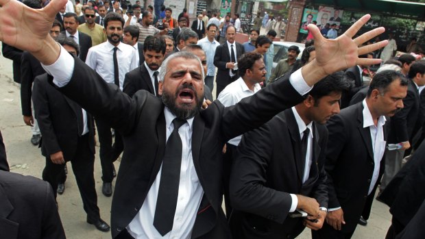 A Pakistan lawyer  in Lahore shouts slogans during a demonstration to condemn the suiciding bombing in Quetta.