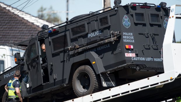 Victoria Police's Lenco BearCat is towed from the scene of the St Albans siege. 