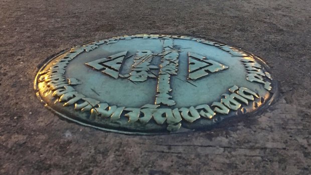 The small bronze plaque in the Royal Plaza commemorated Thailand's 1932 revolution.