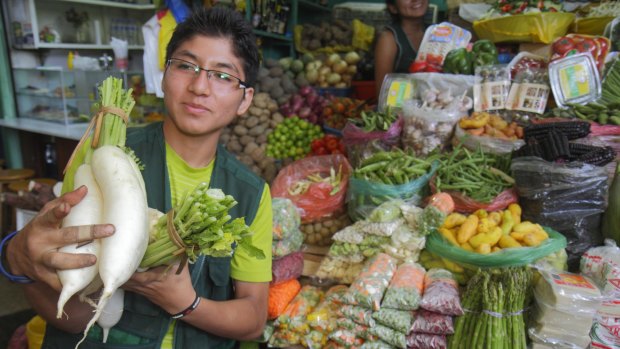 A vegetable vendor at Lima's Surquillo market, start of the culinary adventure. 