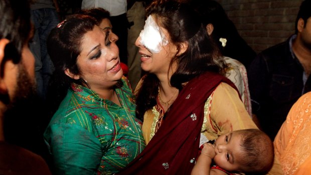 A woman injured in the bomb blast is comforted by a relative at a hospital in Lahore on Sunday. 