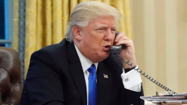 US President Donald Trump speaks on the phone with Prime Minister Malcolm Turnbull in the Oval Office of the White House in Washington.