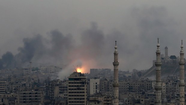 Fire rises following a Syrian government air strike that hit rebel positions in the eastern neighborhoods of Aleppo, Syria, on Monday.