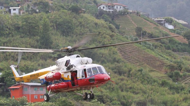 Rescue mission: A helicopter leaves Kundasang, Malaysia, to recover the bodies of victims on Mount Kinabalu.