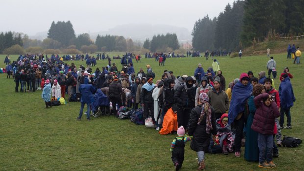 Refugees wait at the German-Austrian border near Wegscheid on Thursday.