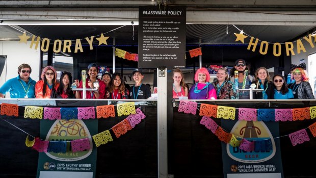 The bar staff in dress-up mode in cafe de canvas, a massive tent with a bar attached which travels with the ride.