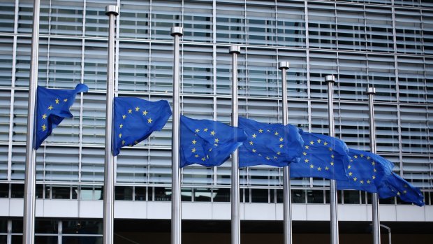 The European Union flag flies at half mast outside EU Commission Headquarters in Brussels.