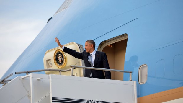 US President Barack Obama waves before boarding Air Force One at Amberley.