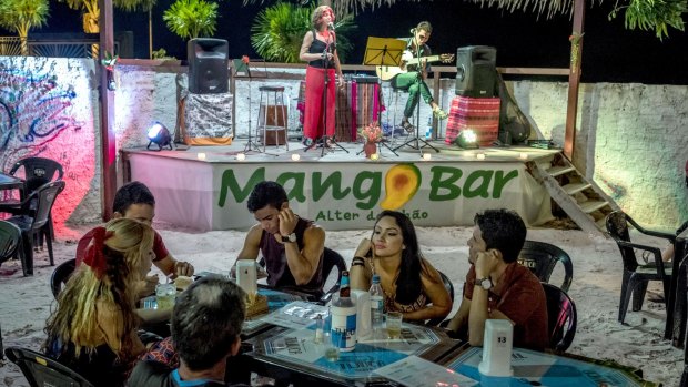 Musicians at Mango Bar, where patrons can enjoy drinks made with local fruits, in Alter Do Chao.