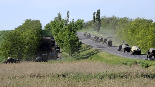 Military vehicles drive along a road at the Russian southern town of Matveev Kurgan, near the Russian-Ukrainian border in Rostov region, Russia on May 24.