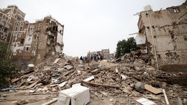 People search for survivors under the rubble of houses destroyed by an air strike in Sanaa earlier this week.
