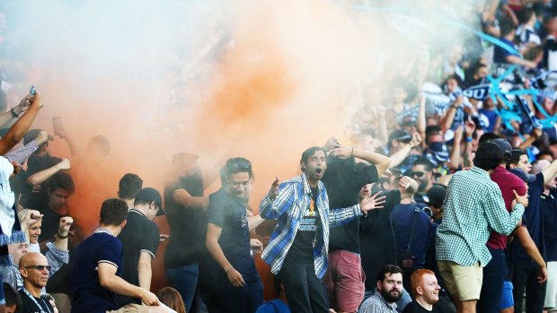 Fanning the flames: Melbourne Victory fans set off a flare during Saturday's Melbourne derby.