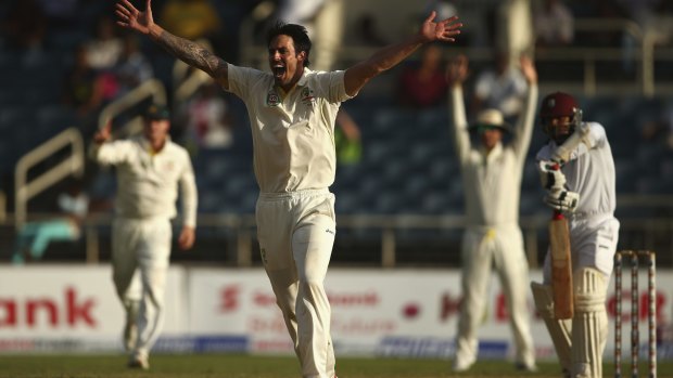 Australia's Mitch Johnson successfully - after a review - snares the wicket of West Indies tailender Veerasammy Permaul, who was caught behind to end day two of the second Test at Sabina Park, Jamaica.