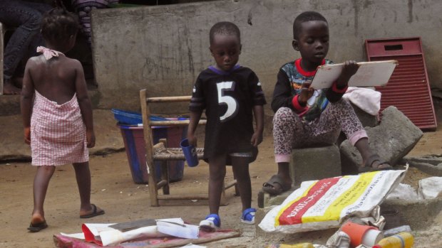 Children in front of their home on the outskirts of Monrovia on Liberia earlier this month, quarantined since a  17-year-old boy who lived nearby died from the Ebola virus in a disturbing resurgence of the disease.