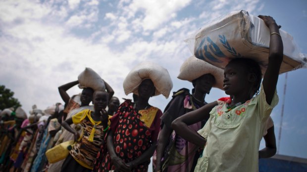 A young girl who fled fighting in nearby Leer in recent months, queues for food aid at a food distribution made by the World Food Programme in Bentiu, South Sudan. 