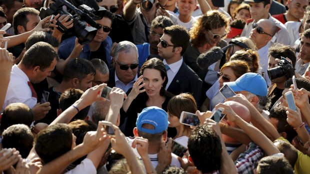 Angelina Jolie is surrounded by Yazidi refugees, officials and media members as she visits a Syrian and Iraqi refugee camp.